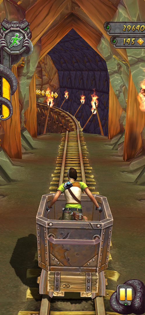 Temple Run 2 scene of riding a mining kart down train tracks through a cavern